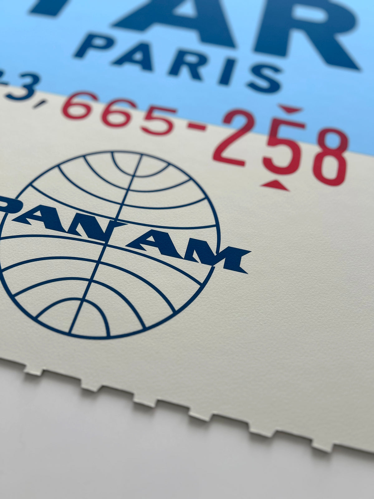 Limited-edition archival print of a Pan Am “Paris” luggage tag by Ella Freire, inspired by the original 1960s design, supersized in two framed sizes, float-mounted to enhance its three-dimensional effect; officially licensed by Pan Am with signed certificate included.