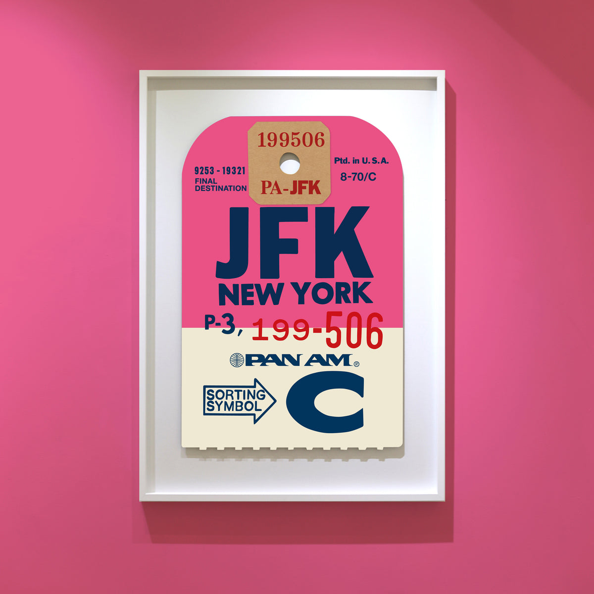 Limited-edition archival print of a Pan Am “JFK New York” luggage tag by Ella Freire, inspired by the original 1960s design, supersized in two framed sizes, float-mounted to enhance its three-dimensional effect; officially licensed by Pan Am with signed certificate included.