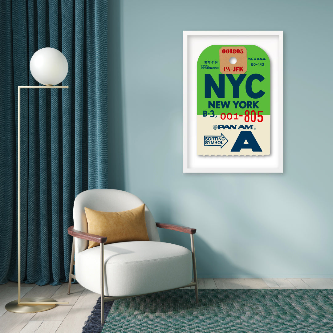 Limited-edition archival print of a Pan Am “NYC New York” luggage tag by Ella Freire, inspired by the original 1960s design, supersized in two framed sizes, float-mounted to enhance its three-dimensional effect; officially licensed by Pan Am with signed certificate included.