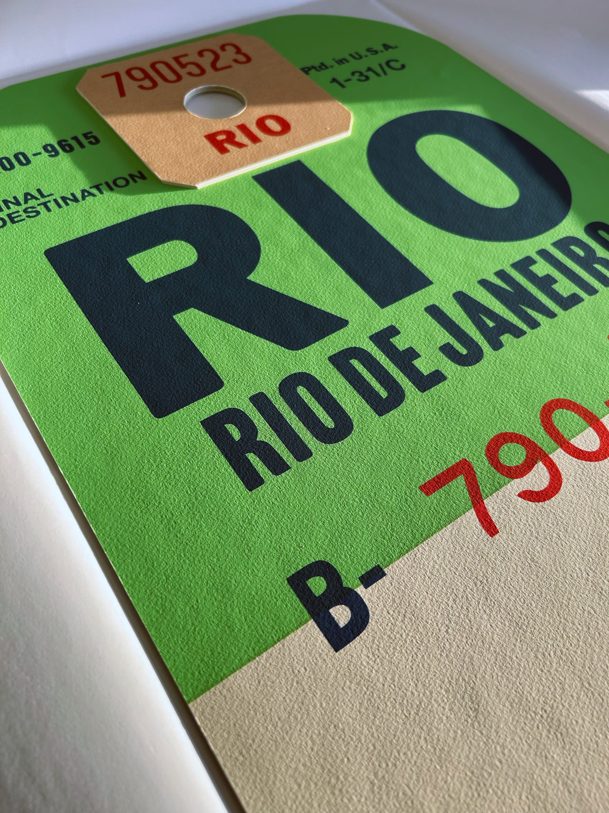 Limited-edition archival print of a Pan Am “Rio de Janeiro” luggage tag by Ella Freire, inspired by the original 1960s design, supersized in two framed sizes, float-mounted to enhance its three-dimensional effect; officially licensed by Pan Am with signed certificate included.
