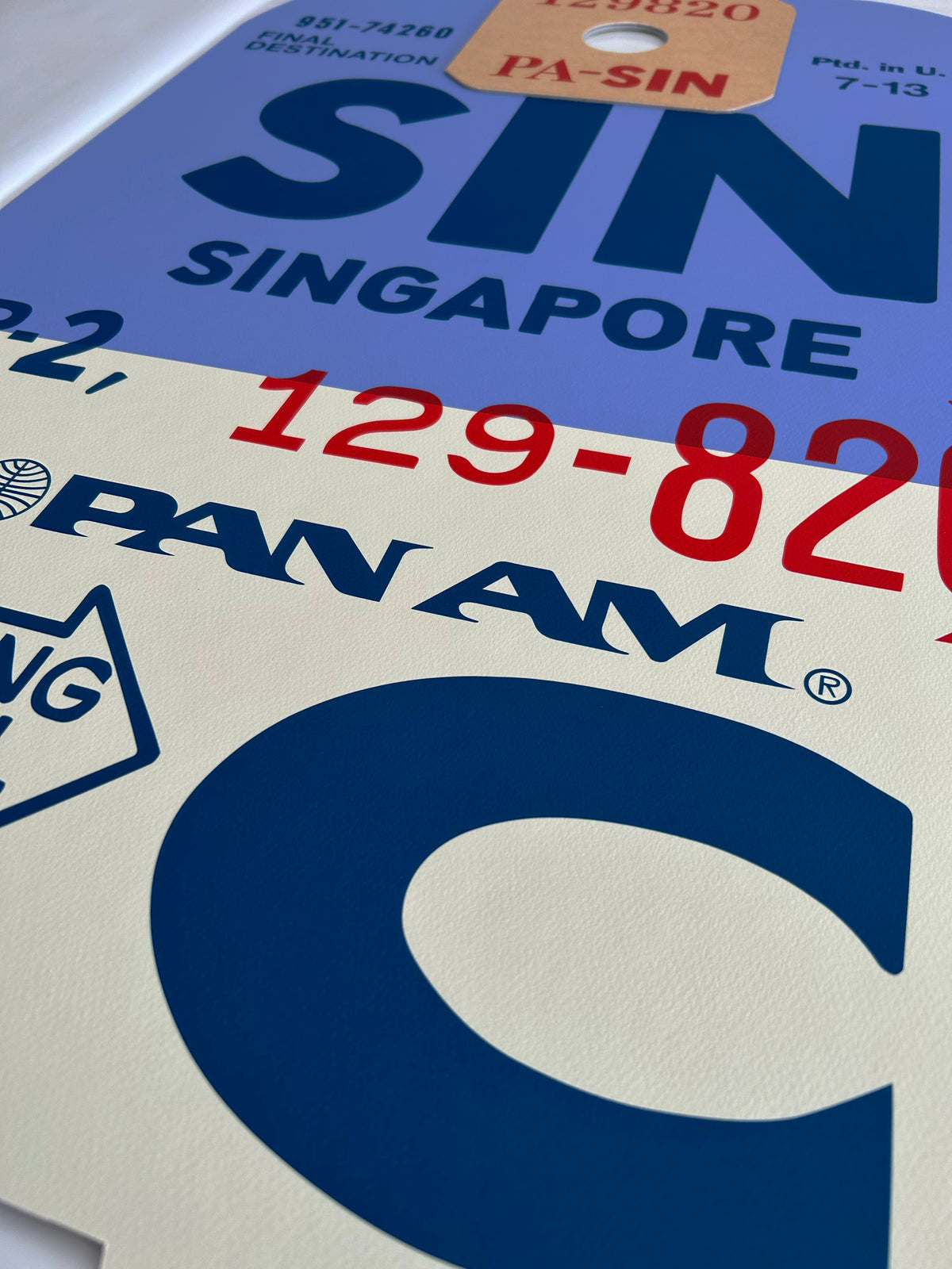 Limited-edition archival print of a Pan Am “Singapore” luggage tag by Ella Freire, inspired by the original 1960s design, supersized in two framed sizes, float-mounted to enhance its three-dimensional effect; officially licensed by Pan Am with signed certificate included.
