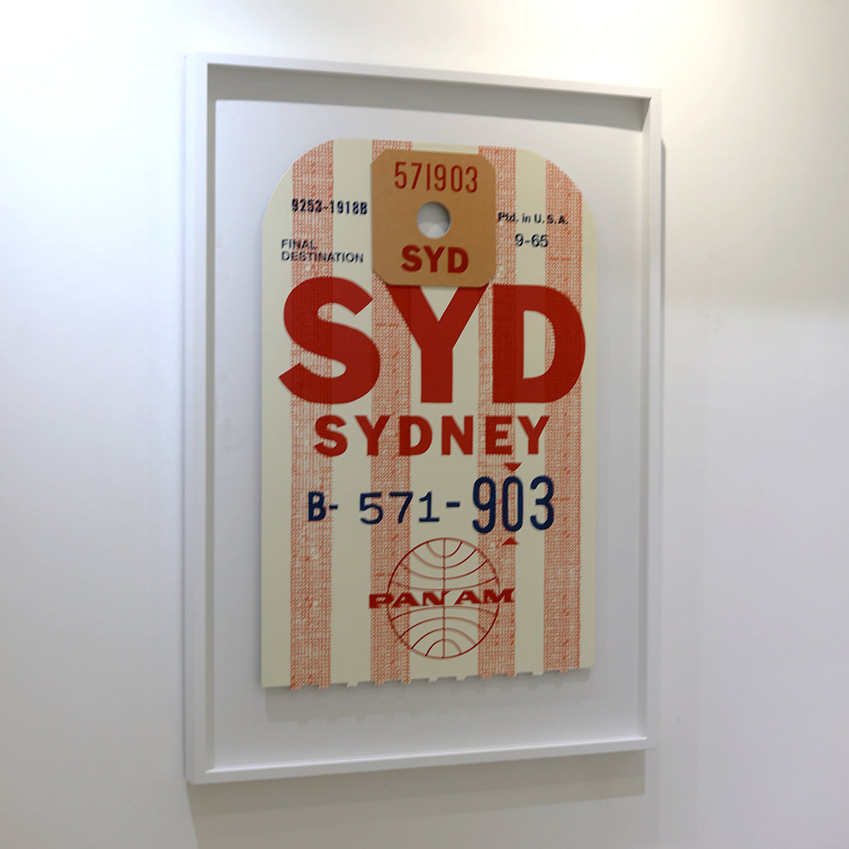 Limited-edition archival print of a Pan Am “Sydney” luggage tag by Ella Freire, inspired by the original 1960s design, supersized in two framed sizes, float-mounted to enhance its three-dimensional effect; officially licensed by Pan Am with signed certificate included.