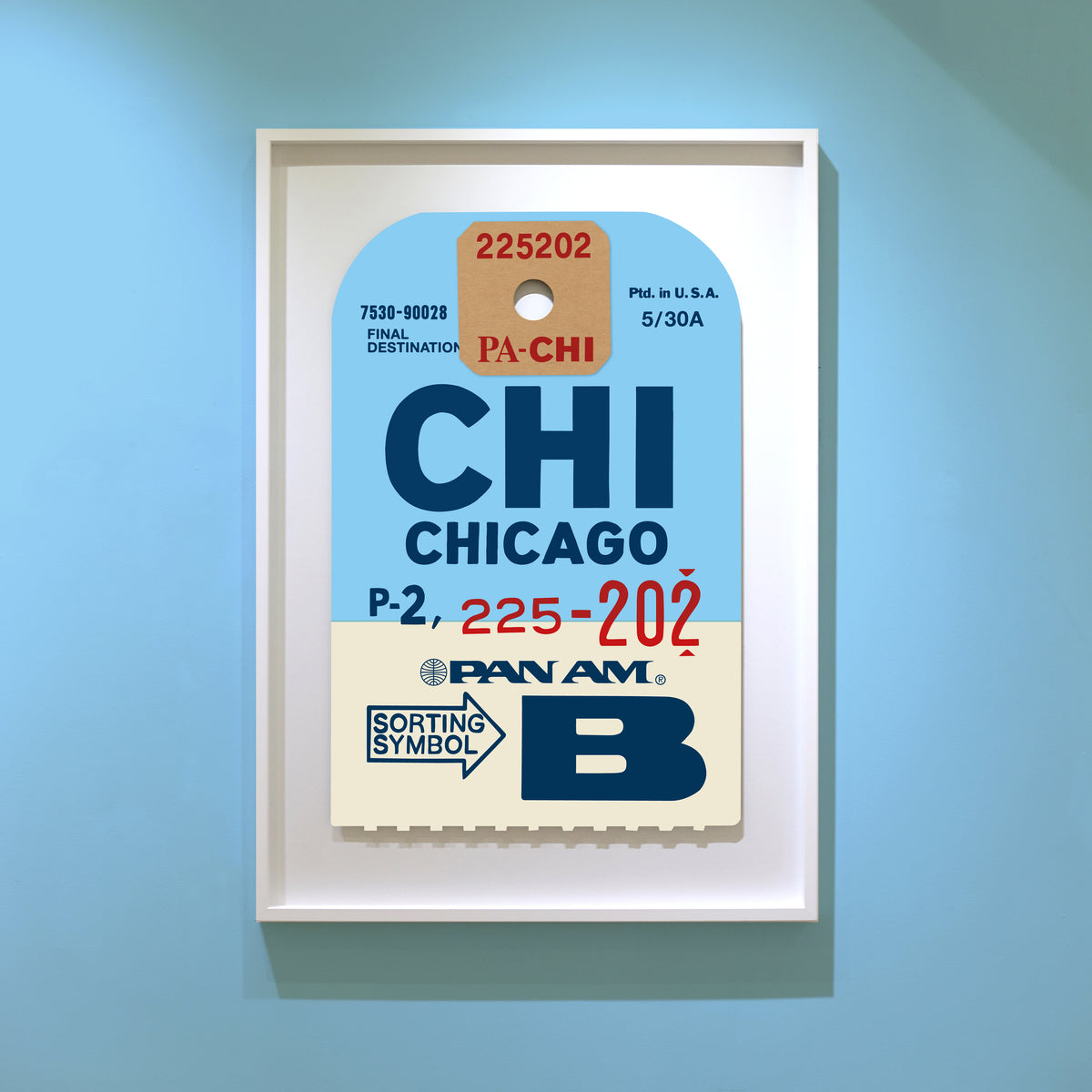 Limited-edition archival print of a Pan Am “Chicago” luggage tag by Ella Freire, inspired by the original 1960s design, supersized in two framed sizes, float-mounted to enhance its three-dimensional effect; officially licensed by Pan Am with signed certificate included.