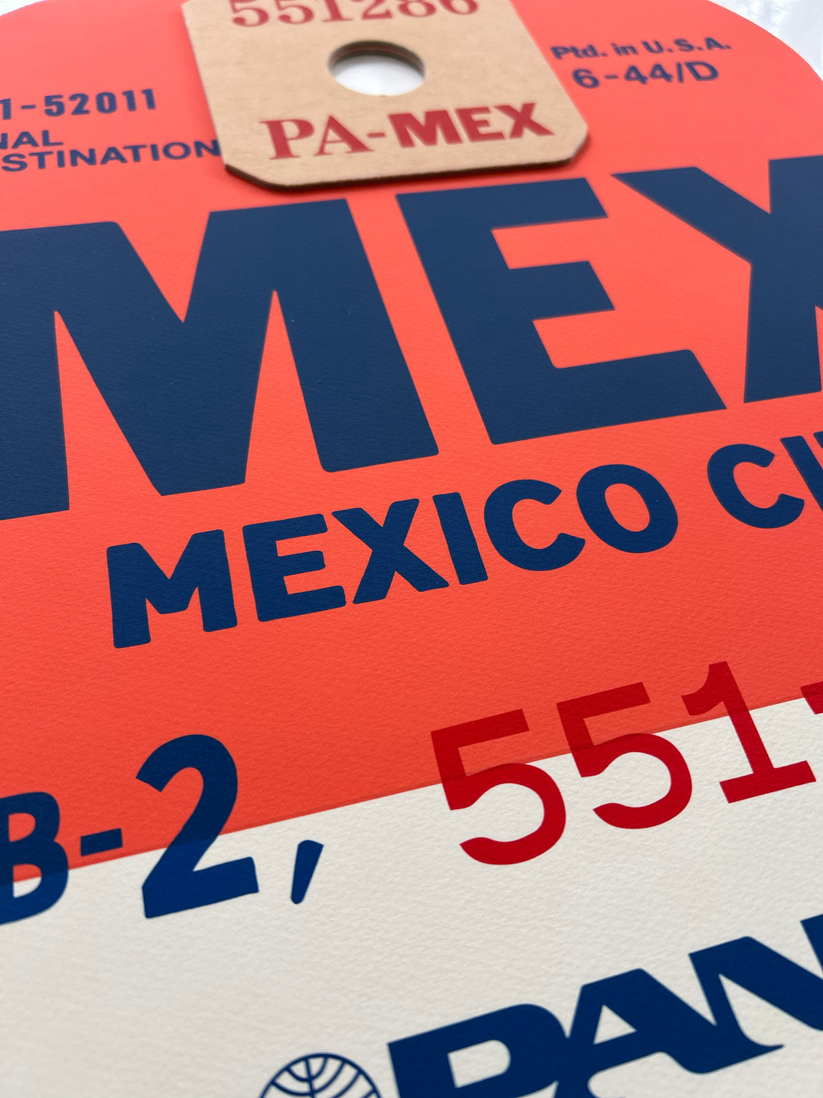 Limited-edition archival print of a Pan Am “Mexico City” luggage tag by Ella Freire, inspired by the original 1960s design, supersized in two framed sizes, float-mounted to enhance its three-dimensional effect; officially licensed by Pan Am with signed certificate included.
