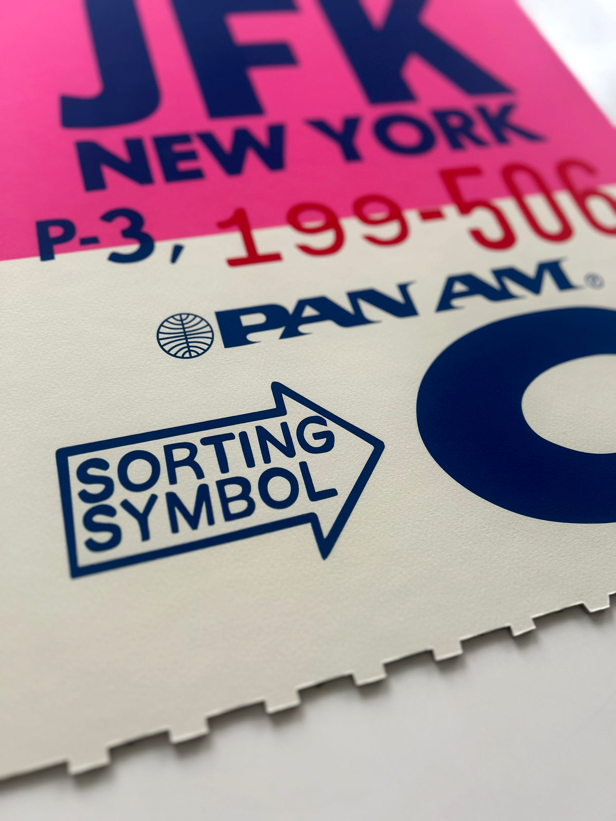 Limited-edition archival print of a Pan Am “JFK New York” luggage tag by Ella Freire, inspired by the original 1960s design, supersized in two framed sizes, float-mounted to enhance its three-dimensional effect; officially licensed by Pan Am with signed certificate included.