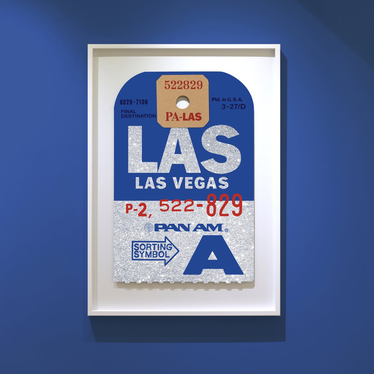 Limited-edition archival print onto sliver glitter paper of a Pan Am “Las Vegas” luggage tag by Ella Freire, inspired by the original 1960s design, supersized to a large size, float-mounted to enhance its three-dimensional effect; officially licensed by Pan Am with signed certificate included.