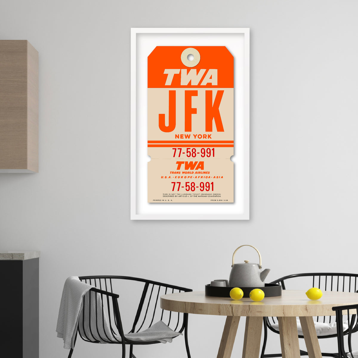 Limited-edition archival print of a TWA “JFK New York” luggage tag by Ella Freire, inspired by the original 1960s design, supersized in one framed size only, float-mounted to enhance its three-dimensional effect; officially licensed by TWA (American Airlines) with signed certificate included.